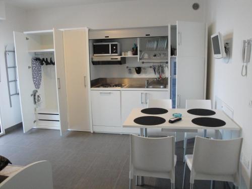 a kitchen with a table and chairs in a room at Residence La Nave in Senigallia