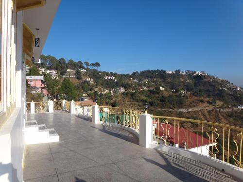 a balcony of a building with a view of a mountain at Aqua De Vida in Bhowāli