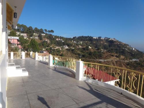 a balcony of a building with a view of a mountain at Aqua De Vida in Bhowāli