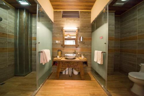 a bathroom with a sink and a toilet at Dreamer Inn in Lijiang