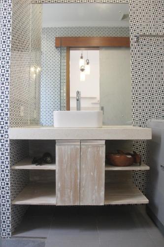 a bathroom with a sink and a mirror at Green Studio Apartment Seminyak in Seminyak