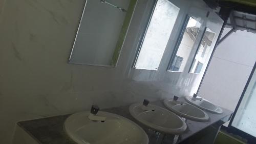 a bathroom with two sinks and a window at Colombo Downtown Monkey Backpackers Hostel in Colombo