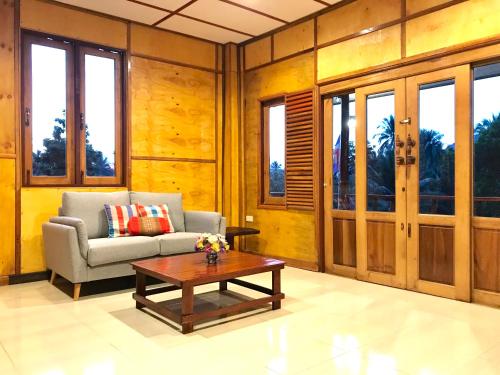 a living room with a couch and a coffee table at Kiri Tawan in Baan Tai