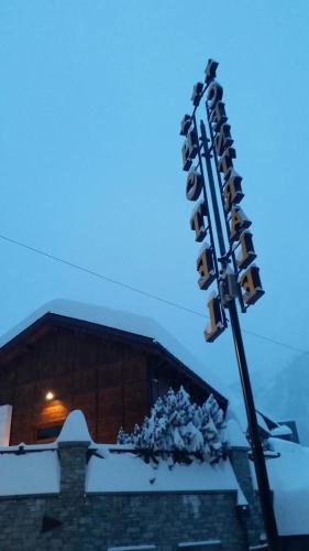 a traffic light on a pole with snow on it at Centrale in Courmayeur