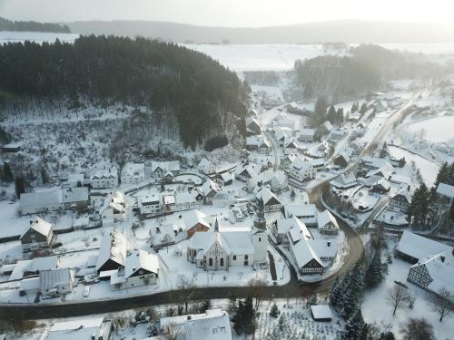 an aerial view of a village covered in snow at Lauras Landhauspension in Medebach