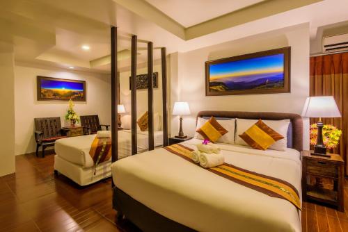 Un pat sau paturi într-o cameră la Panna Heritage Boutique Hotel - SHA Plus