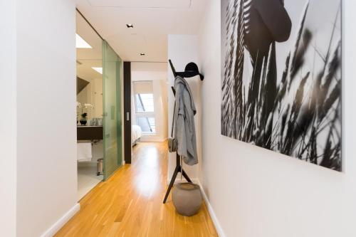a hallway of a house with a painting on the wall at RAFAEL KAISER - Premium Apartments City Centre - Contactless Check-In in Vienna