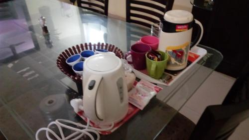 a kitchen counter with a mixer on a glass table at Tranquil Hospitality with Breakfast in Bhubaneshwar