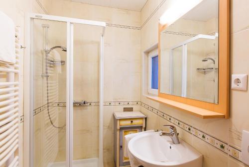 a bathroom with a sink and a shower at Apartments Dolar in Bled