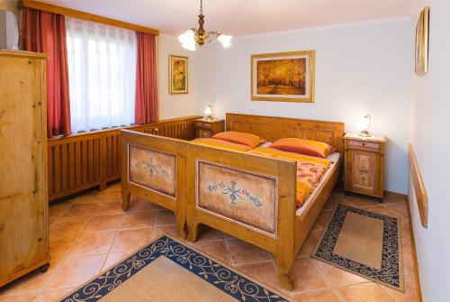 a bedroom with two wooden beds and a window at Apartments Dolar in Bled