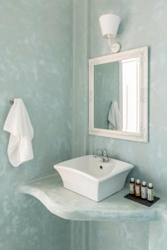 a bathroom with a white sink and a mirror at Eneos Kythnos Beach Villas-Elegant and Comfort Villas in Kithnos
