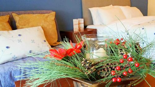 a vase with a christmas arrangement on a table at Asteras Hotel in Naousa Imathias