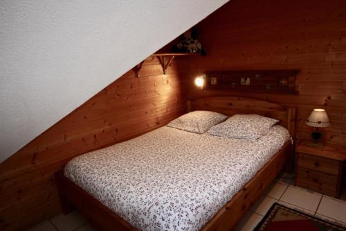レ・デュー・アルプにあるGrande chaume 5.1 : Centre station, à 200m du télésiègeの木造キャビン内のベッド1台が備わるベッドルーム1室を利用します。