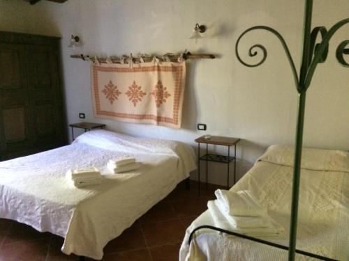 a bedroom with two beds with towels on them at Agriturismo Il Muto di Gallura in Aggius