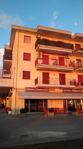 a yellow building with red balconies on a street at Costa d'Amalfi e Cilento in Pontecagnano