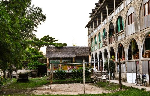 un edificio con una recinzione di fronte di Lobo Hostel - Rurrenabaque a Rurrenabaque