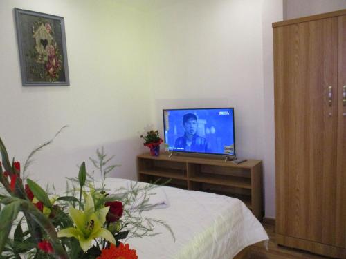 a living room with a television on a table at City Backpackers Hostel in Ho Chi Minh City