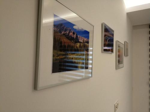 a picture hanging on a wall with paintings on it at Best Home 20 Cleopatra Select in Alanya