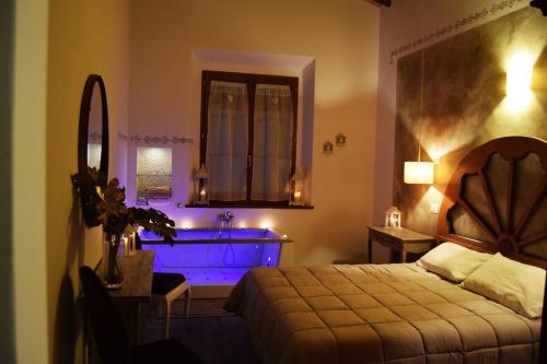a bedroom with a bed and a sink and a mirror at Le Checche in Pienza
