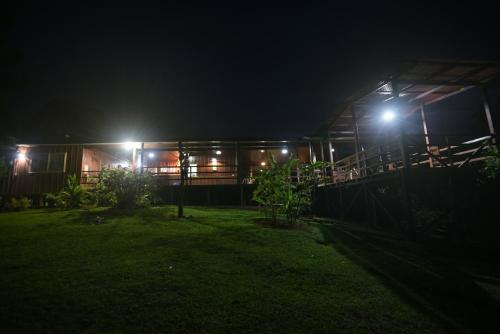 a house lit up at night with lights at La Laguna del Lagarto Eco-Lodge in Pital