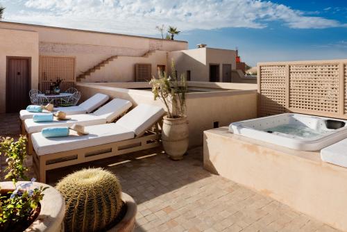 a rooftop patio with a hot tub and a cactus at 72 Hotel & Spa in Marrakech