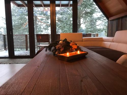 a living room with a wooden table with candles on it at Chata Dorotka in Vyšné Ružbachy