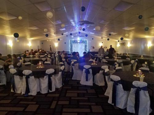 a banquet hall with tables and chairs and people at St. Michaels Inn in Saint Michaels