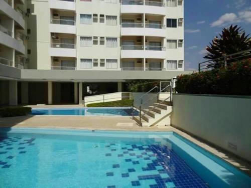 a swimming pool in front of a building at Serra Park Flat 420 in Rio Quente