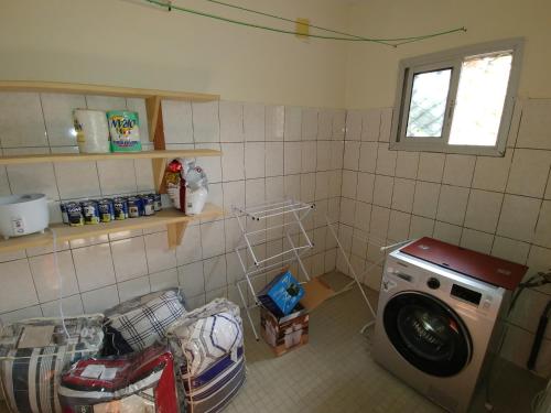 a laundry room with a washing machine in it at Rose Garden Apartments in Limbe