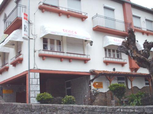 a large white building with balconies on it at Mikotania in Covilhã