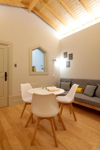 a living room with a table and chairs and a couch at LOFT Sá de Noronha in Porto