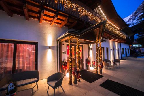 a patio with christmas decorations on a building at Residence Langes in San Martino di Castrozza