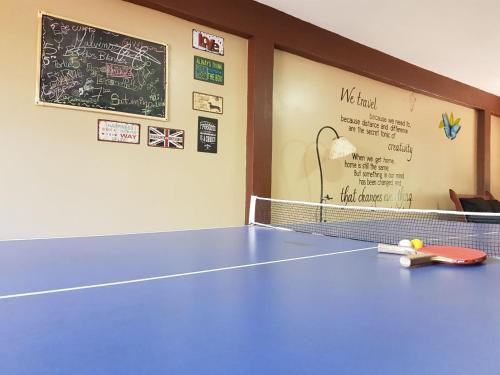 a ping pong table in a room with a chalkboard at Hostel Park Iguazu in Puerto Iguazú