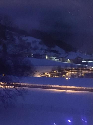 a night view of a road with lights in the snow at Agriroom in Rumo