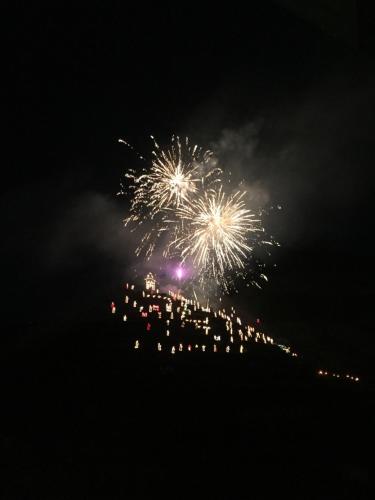 a group of people watching fireworks in the sky at Le Storie di Manarola in Manarola