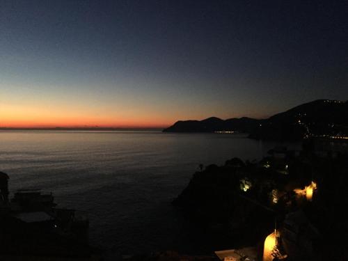 a view of a body of water at sunset at Le Storie di Manarola in Manarola