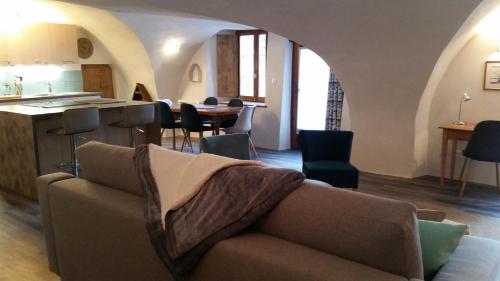 a living room with a couch and a table at Maison à Tour Briançon in Briançon