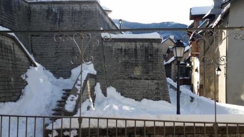 a brick building with snow on the side of it at Maison à Tour Briançon in Briançon