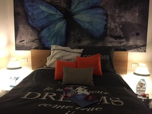a bedroom with a bed with a blue butterfly wall at Le Storie di Manarola in Manarola