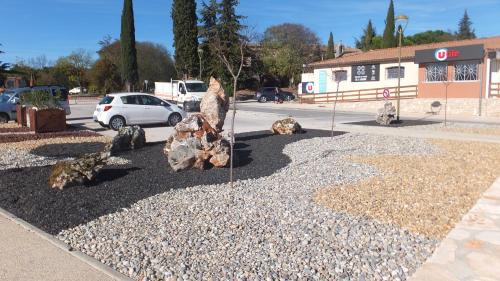 a group of rocks sitting in a parking lot at La Cèzenole in Méjannes-le-Clap
