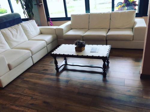 a living room with a white couch and a coffee table at Hotel Bauer in Torres