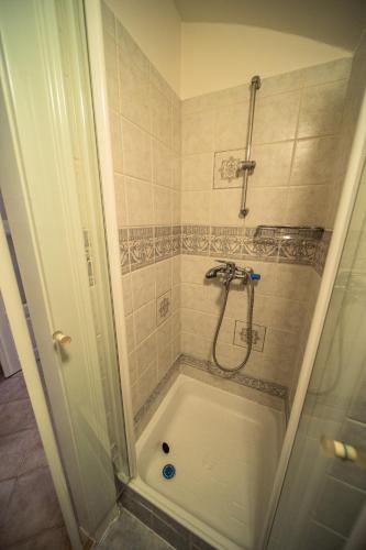 a bathroom with a shower with a tub at St. George Apartments in Prague