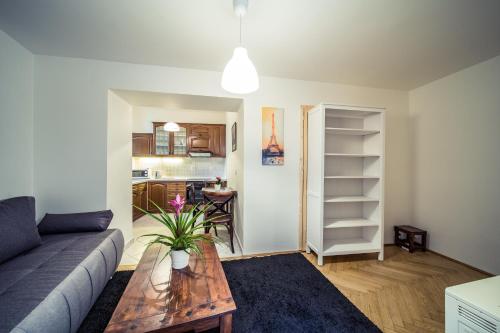 a living room with a couch and a table at St. George Apartments in Prague