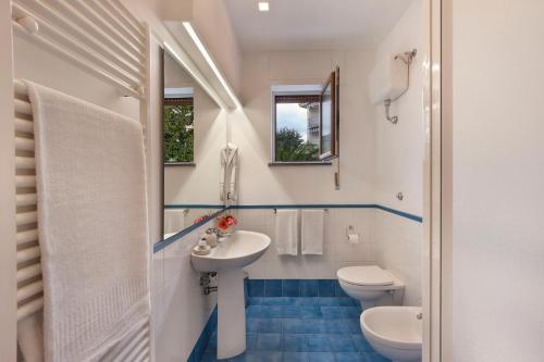 a bathroom with a sink and a toilet at Casa Aurora in Sorrento