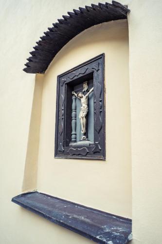 a statue on the side of a wall at St. George Apartments in Prague