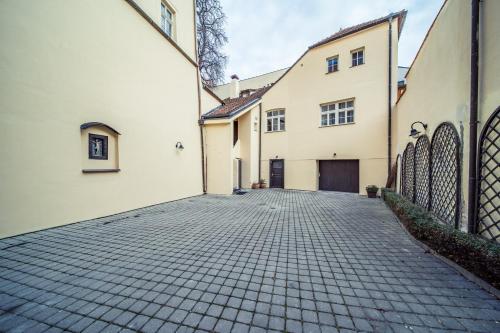 a cobblestone street in front of two buildings at St. George Apartments in Prague