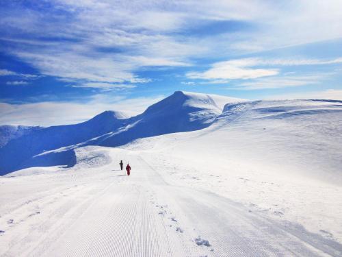 two people walking on a snow covered mountain at Янтри in Dragobrat