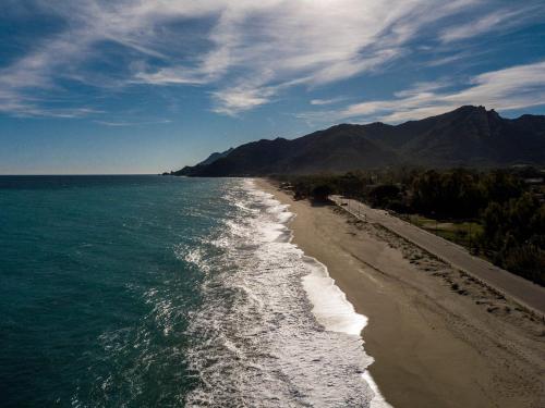 an aerial view of a beach with the ocean at Ville D'Ogliastra in Cardedu