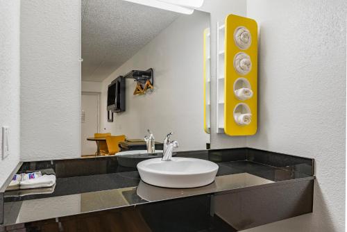 a bathroom with a sink and a mirror at Days Inn by Wyndham Cincinnati I-71 in Cincinnati