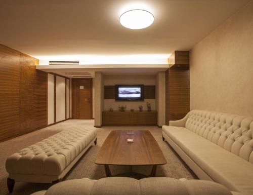 a living room with a couch and a table at Grand Hotel Gaziantep in Gaziantep